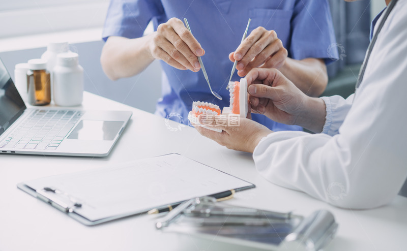 高清大图下载【趣麦麦图】正在塑料颌模型上练习的牙医