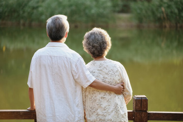 一对老年夫妻在湖边的温馨场景