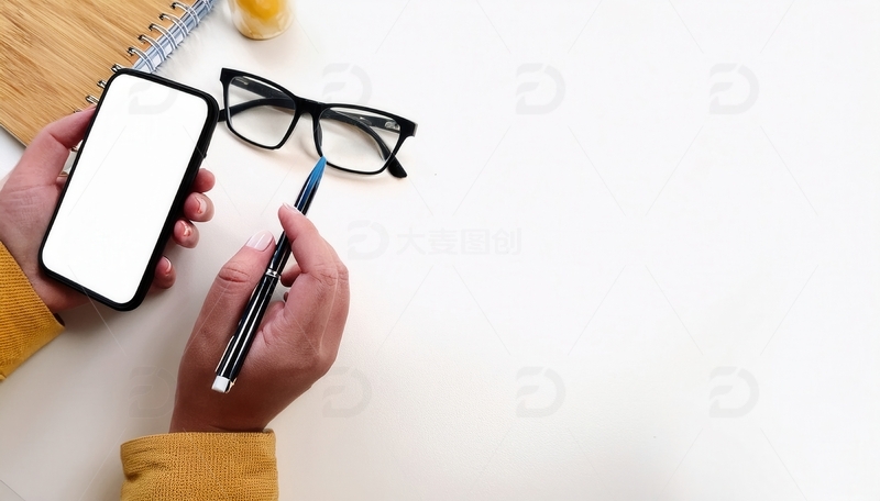 高清大图下载【趣麦麦图】手持手机，手边摆放眼镜和钢笔