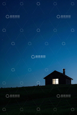 夜色中亮灯小屋与星空