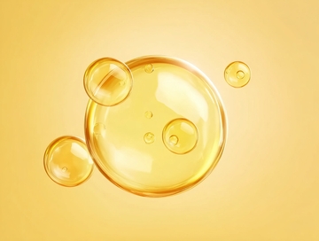 金黄色液体气泡在柔和背景中漂浮