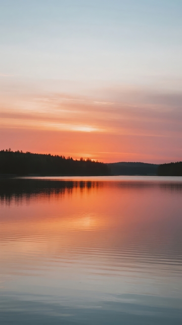 湖面平静夕阳映照天际色彩斑斓