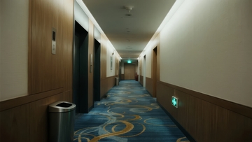 酒店走廊铺有蓝色花纹地毯两侧为木质墙面