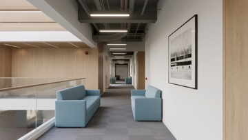 现代办公楼走廊配备蓝色沙发和艺术画作