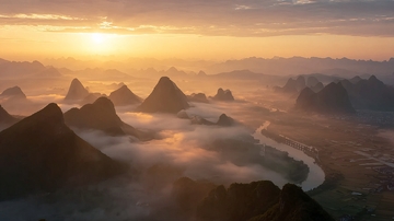 云雾缭绕的山峦与蜿蜒河流的壮丽自然景观