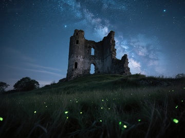 星空下的古老废墟与萤火虫