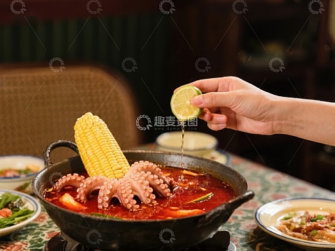 挤柠檬汁入海鲜火锅