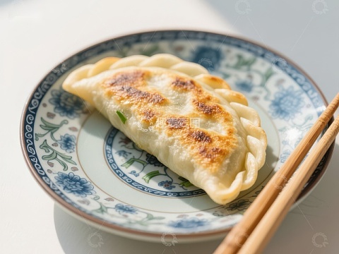 金黄煎饺配蓝花瓷盘