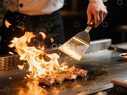 铁板烧厨师翻炒火焰中的食材